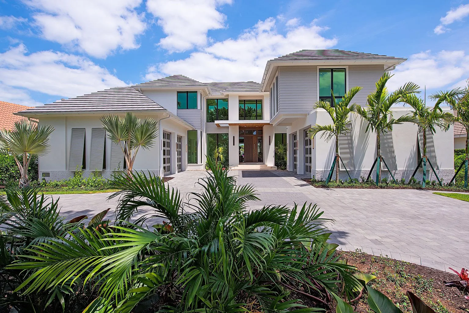 Front elevation of 2999 Rum Row framed by palms