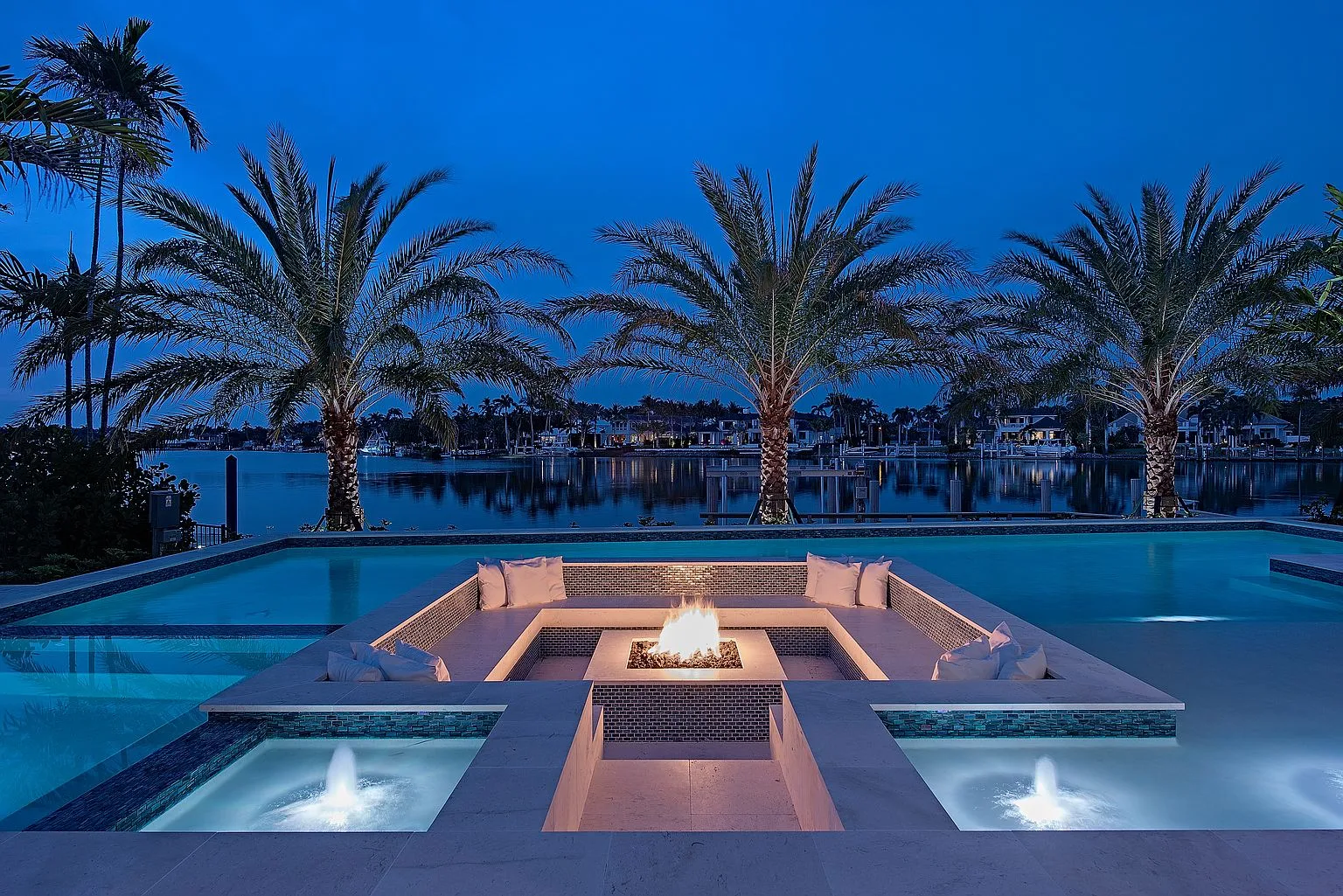 Sunken fire lounge at blue hour beside the waterway